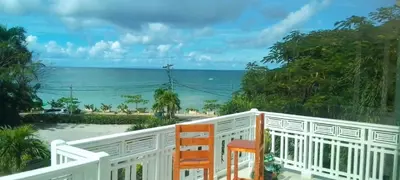 a balcony with a view of the ocean at Apartment mit Meerblick direkt an der Playa Popy in Las Terrenas