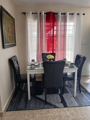 a dining room table with chairs and a window at SDQ Apartment Marbella 4 in La Ureña