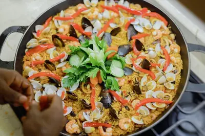 a pizza with seafood and vegetables in a pan at Beachfront Villa Tabiki at Playa Coson, Las Terrenas, Dominicana in Las Terrenas