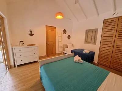 a bedroom with a bed and a dresser in a room at Beachfront Villa Tabiki at Playa Coson, Las Terrenas, Dominicana in Las Terrenas