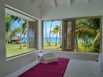 a bedroom with a bed with a view of the ocean at Beachfront Villa Tabiki at Playa Coson, Las Terrenas, Dominicana in Las Terrenas