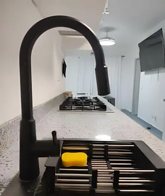 a kitchen with a stove with a yellow burner at Bayahibe Rose C - Gray Elegance in San Rafael del Yuma