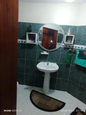 a bathroom with a sink and a mirror at Residencial Oasis in Juan López