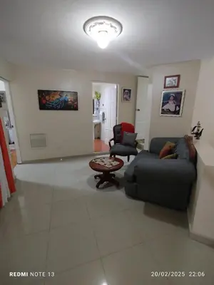 a living room with a couch and a table at Residencial Oasis in Juan López