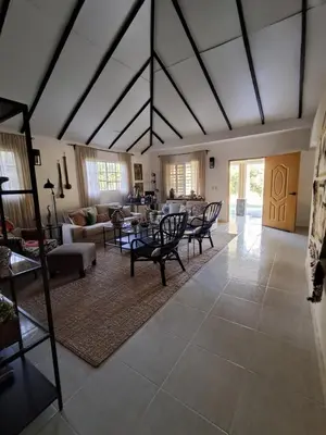 a living room with couches and a table and chairs at Villa la casita in Villa Altagracia