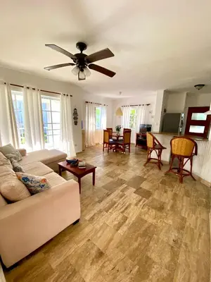 a living room with a couch and a ceiling fan at Fantástico Lugar en el Centro de los Corales RD in Punta Cana