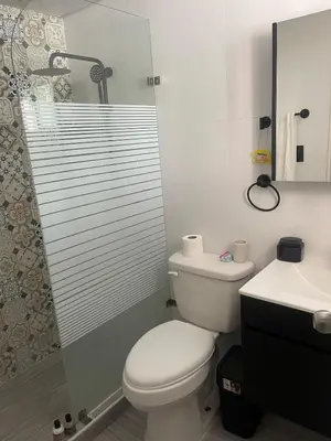 a bathroom with a toilet and a sink and a shower at Apartamento Bello y Amueblado in Jacagua