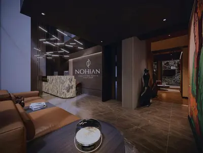 a lobby with a couch and a table in a room at Nohian Collection Hotels in Santiago de los Caballeros