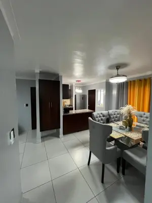 a living room with a dining table and a couch at Apartamento amueblado in Arenoso