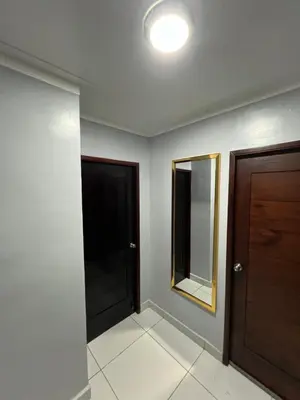 a hallway with two doors and a mirror at Apartamento amueblado in Arenoso