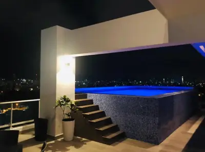 a room with a blue swimming pool in a building at Natural Boho Places QDA-III in Santo Domingo