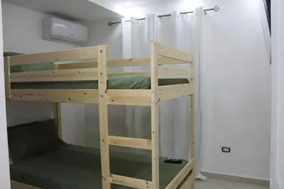 a wooden bunk bed in a small room at Cozy Apt with Puerto Plata view in San Felipe de Puerto Plata