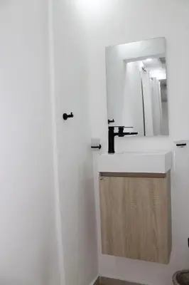 a bathroom with a sink and a mirror at Cozy Apt with Puerto Plata view in San Felipe de Puerto Plata