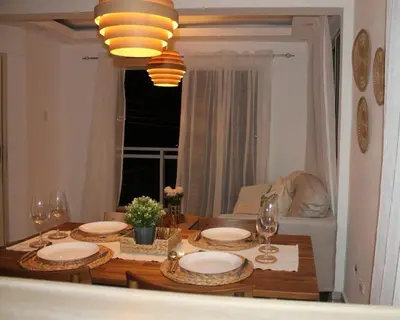 a dining room table with plates and wine glasses at Cozy Apt with Puerto Plata view in San Felipe de Puerto Plata