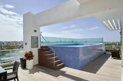 a house with a swimming pool and a patio at Luxury and Cozy Places QDA-II in Santo Domingo