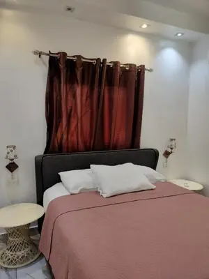 a bedroom with a bed with a red curtain at Vacacional Laas Pascualas in Sánchez