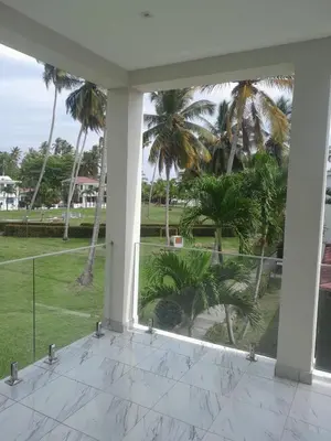 a view from the porch of a house with palm trees at Vacacional Laas Pascualas in Sánchez