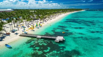 an aerial view of a beach with chairs and umbrellas at Cozy Condo - 4 min to the Beach in Punta Cana