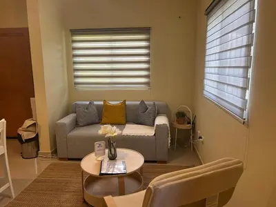 a living room with a couch and a table at Villa Atlantica Punta Cana in Punta Cana