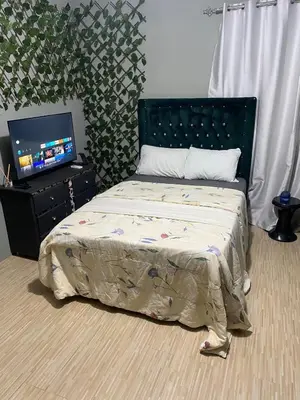a bedroom with a bed and a flat screen tv at Habitación a 15min del aeropuerto in La Caleta
