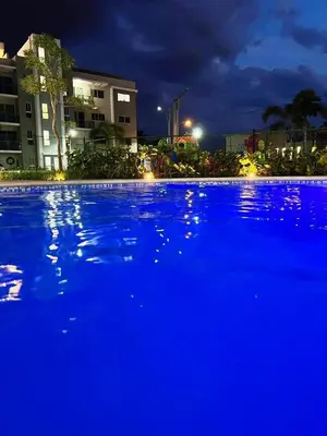 a large blue swimming pool at night at Lux 3BR Oasis With Gazebo & Pool in Pontezuela Arriba