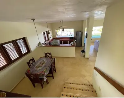 a room with a table and chairs and a kitchen at Villa with Stunning Ocean View, Infinity pool in Las Terrenas