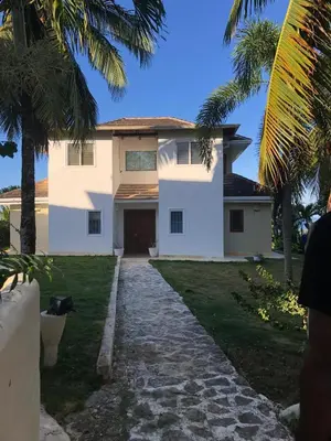 a white house with palm trees and a driveway at Villa with Stunning Ocean View, Infinity pool in Las Terrenas