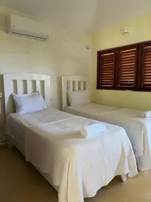 a bedroom with two beds with white sheets at Villa with Stunning Ocean View, Infinity pool in Las Terrenas