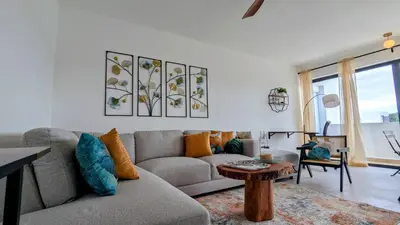 a living room with a couch and a table at Mountain View Penthouse Condo in Muñoz