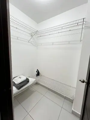 a room with white walls and white tile floors at Apartamento O3 Palma Real in Santiago de los Caballeros