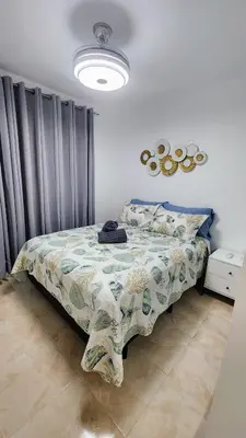 a bedroom with a bed with a blanket on it at vista hermosa in Cabrera
