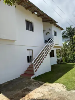 a white house with stairs in front of it at Apartamento Media Luna in Cabrera