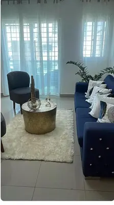 a living room with a blue couch and a coffee table at Exclusive Luxury Apartment with Pool in Santiago de los Caballeros