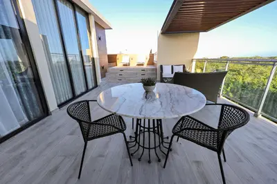 a table and chairs on the balcony of a house at 404 y 504 Luxurious PH with Jacuzzi near the Beach in La Laguna
