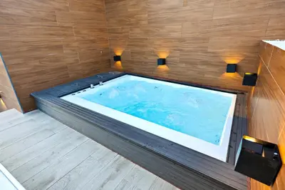 a jacuzzi tub in a room with wooden walls at 404 y 504 Luxurious PH with Jacuzzi near the Beach in La Laguna