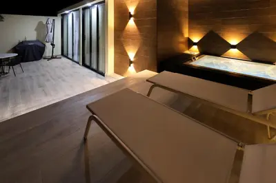 a room with a hot tub and a table at 404 y 504 Luxurious PH with Jacuzzi near the Beach in La Laguna