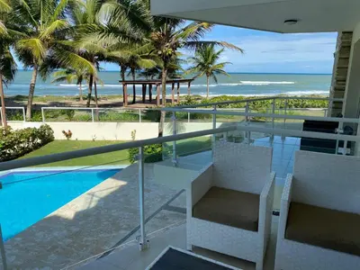 a view of the ocean from the balcony of a house at 0052-Brand new oceanfront condo in Cabarete in Eslabón