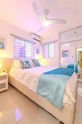 a bedroom with a large bed with a ceiling at Oasis cerca del mar #2 in Monte Adentro