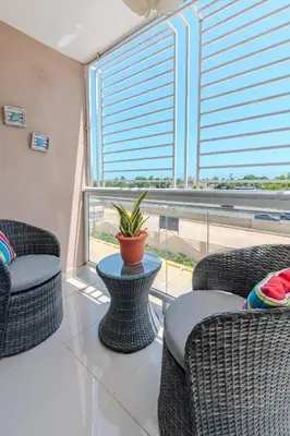a living room with two wicker chairs and a potted plant at Oasis cerca del mar #2 in Monte Adentro