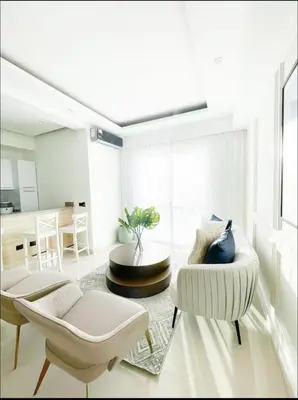 a living room with two chairs and a table at Apartamento boca chica in Andrés