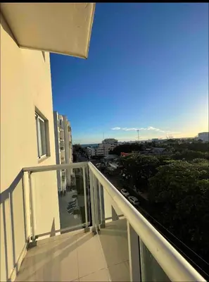 a balcony of a building with a view of a city at Apartamento boca chica in Andrés