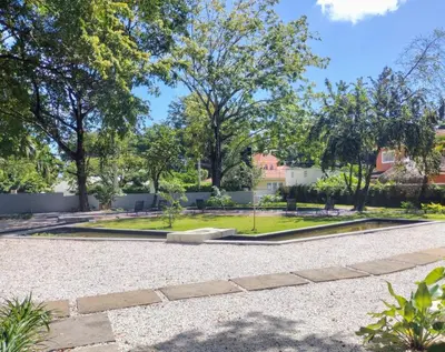 a park with a fountain and trees at Perla Marina Beach Condo- Walk to Yoga, Spa & Food in Sosúa