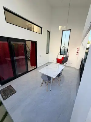 a dining room with a glass table and two chairs at Taina village in Las Terrenas