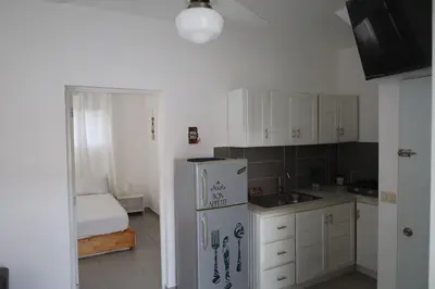 a kitchen with a refrigerator and a sink at Ilaria Bayahibe By Mireya in Bayahibe