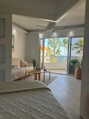 a bedroom with a bed and a view of the ocean at Apartamento lll Vista al Mar Albatros by ju Juan Dolio in Villas del Mar