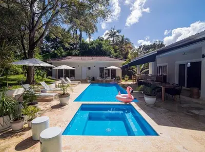 a swimming pool with a pink flamingo in a backyard at Modern 6 Br Villa With Hot Tub in Sosúa