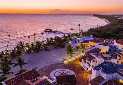 an aerial view of a beach at sunset at Cadaques Bayahibe Beach Front in Bayahibe