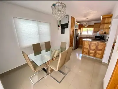 a dining room with a glass table and chairs at pavilus in Punta Cana