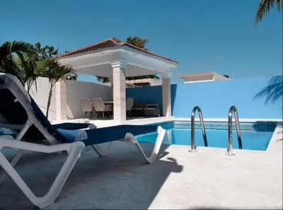 a lounge chair next to a swimming pool at pavilus in Punta Cana