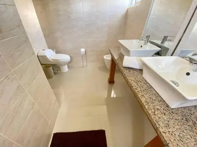a bathroom with a sink and a toilet and a mirror at pavilus in Punta Cana